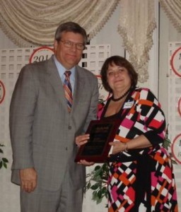 Photo Harold Gates 2010 Board Chair presenting 2010 Business of the Year award to Linda Standley ILMO Products CEO.1 e1298068744606